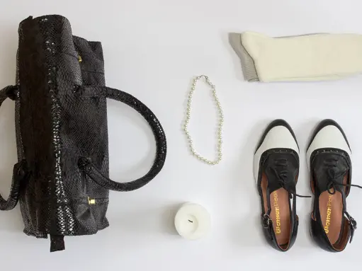 Black shoes with a bag and pearl necklace